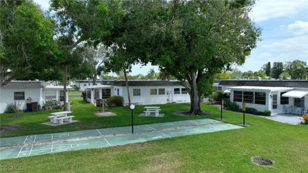 a view of a house with a backyard