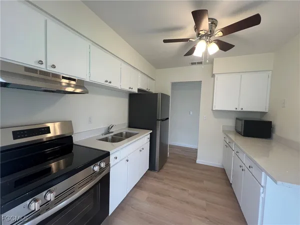 a kitchen with stainless steel appliances a stove a sink and a refrigerator
