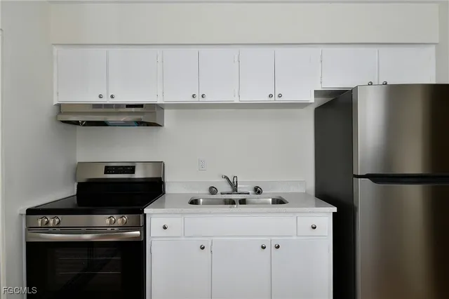 a kitchen with a refrigerator and a stove
