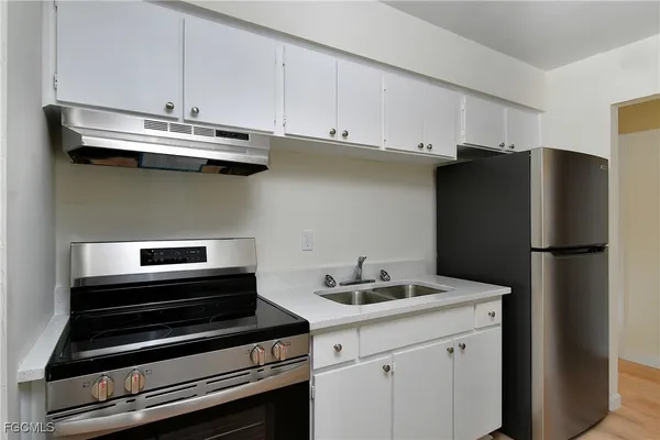 a kitchen with appliances and cabinets