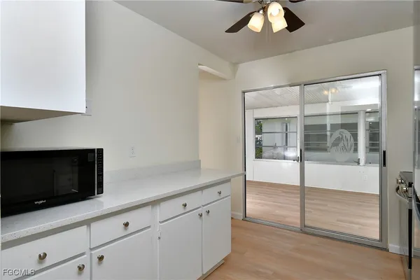 a kitchen with granite countertop a stove and a microwave