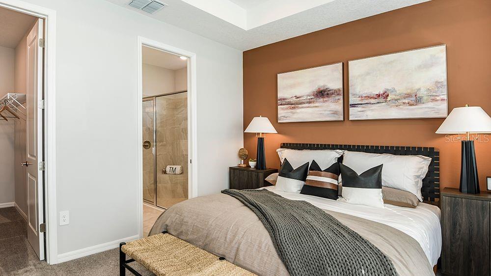 32488 Sea Loch Loop Mount Dora, FL 32757 - Photo 13 of 31 a bedroom with a bed and a large mirror