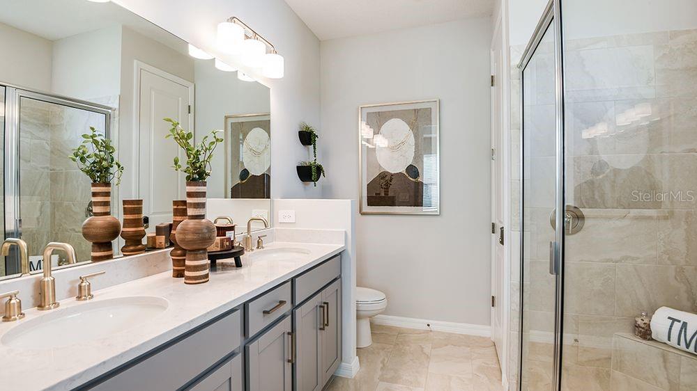 32488 Sea Loch Loop Mount Dora, FL 32757 - Photo 14 of 31 a bathroom with a sink and mirror with toilet