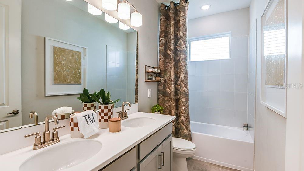 32488 Sea Loch Loop Mount Dora, FL 32757 - Photo 18 of 31 a bathroom with a sink a toilet and shower
