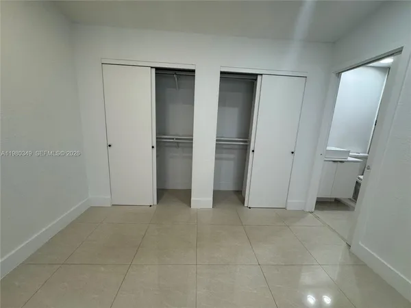 a view of a kitchen with refrigerator stove and cabinets