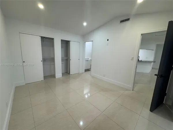 a view of hallway with a sink and a mirror