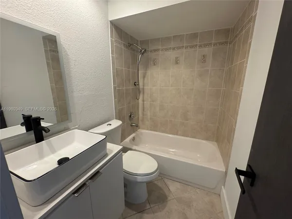a bathroom with a sink a toilet and a bathtub