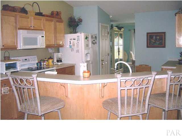 6010 Ridgeview Drive Milton, FL 32570 - Photo 7 of 12 KITCHEN WITH BREAKFAST BAR