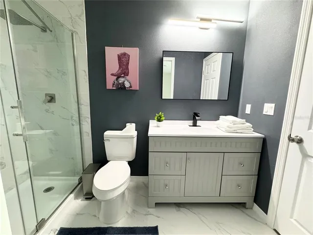 a bathroom with a sink toilet and shower