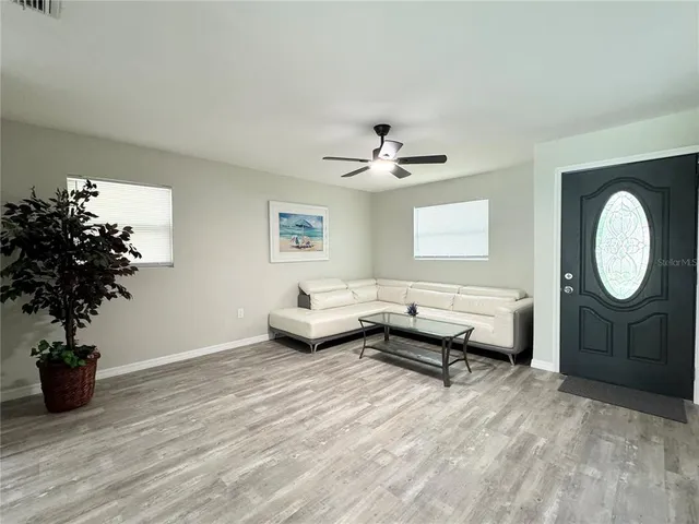 a living room with furniture and a potted plant