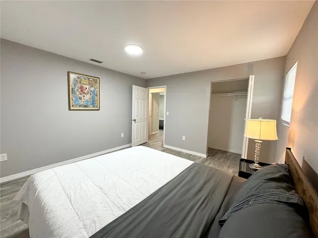 a bed room with a bed and a night stand