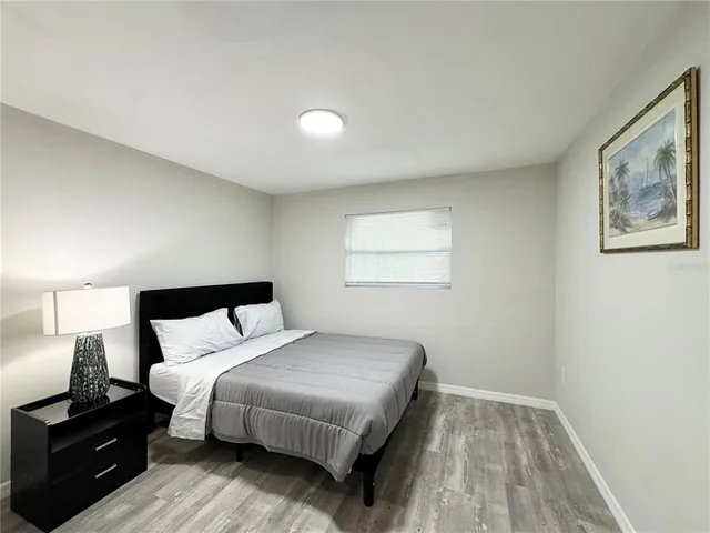 a bedroom with a bed and a night stand