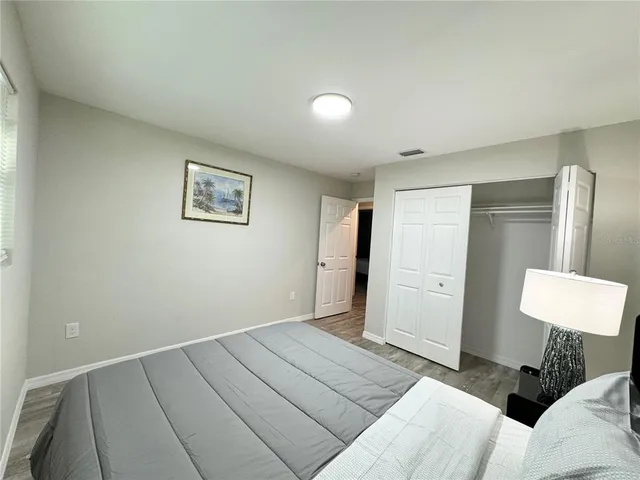 a bedroom with a bed and a lamp
