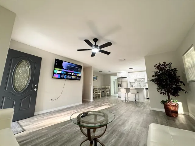 a living room with furniture and a chandelier