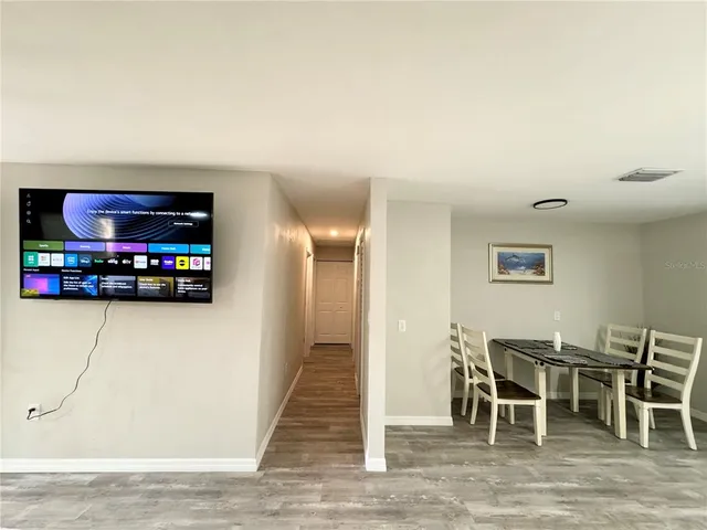 a view of a livingroom with furniture and a flat screen tv