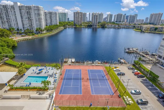 a view of balcony with two chairs and potted plants