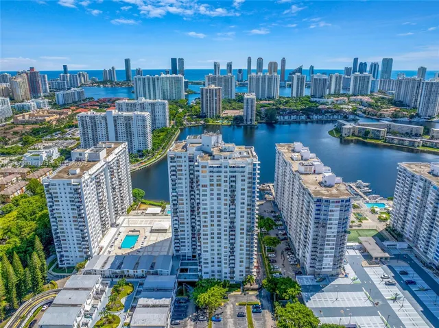 a view of a chairs and table in wooden roof deck