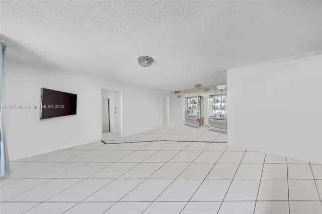 a kitchen with white cabinets a refrigerator and a sink