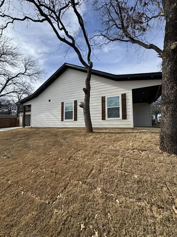 a house that has a tree in front of it