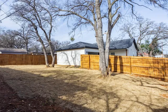 a large house with trees in front of it