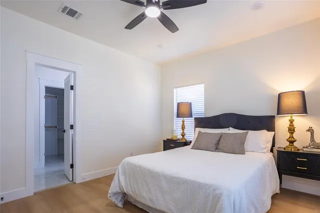 a bedroom with a bed and a lamp