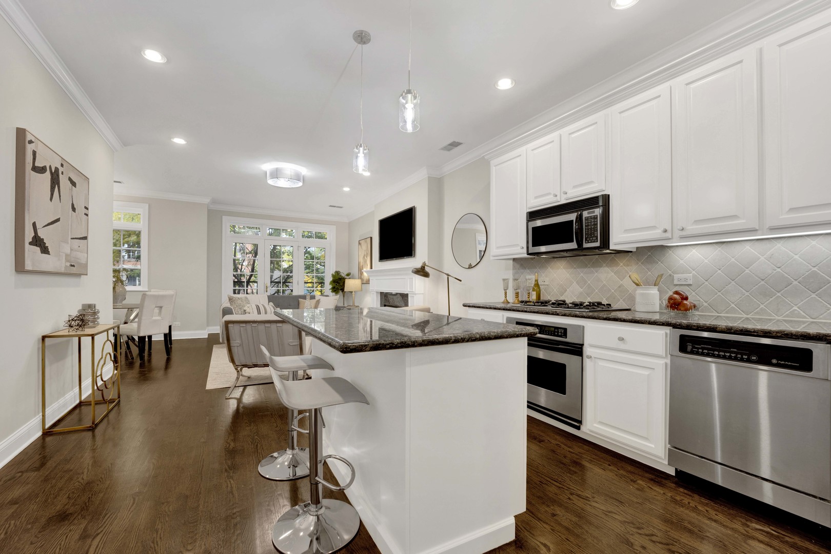 1724 North Mohawk Street, Unit 2 Chicago, IL 60614 - Photo 3 of 24 a kitchen with stainless steel appliances granite countertop a refrigerator a stove top oven a sink dishwasher and white cabinets with wooden floor