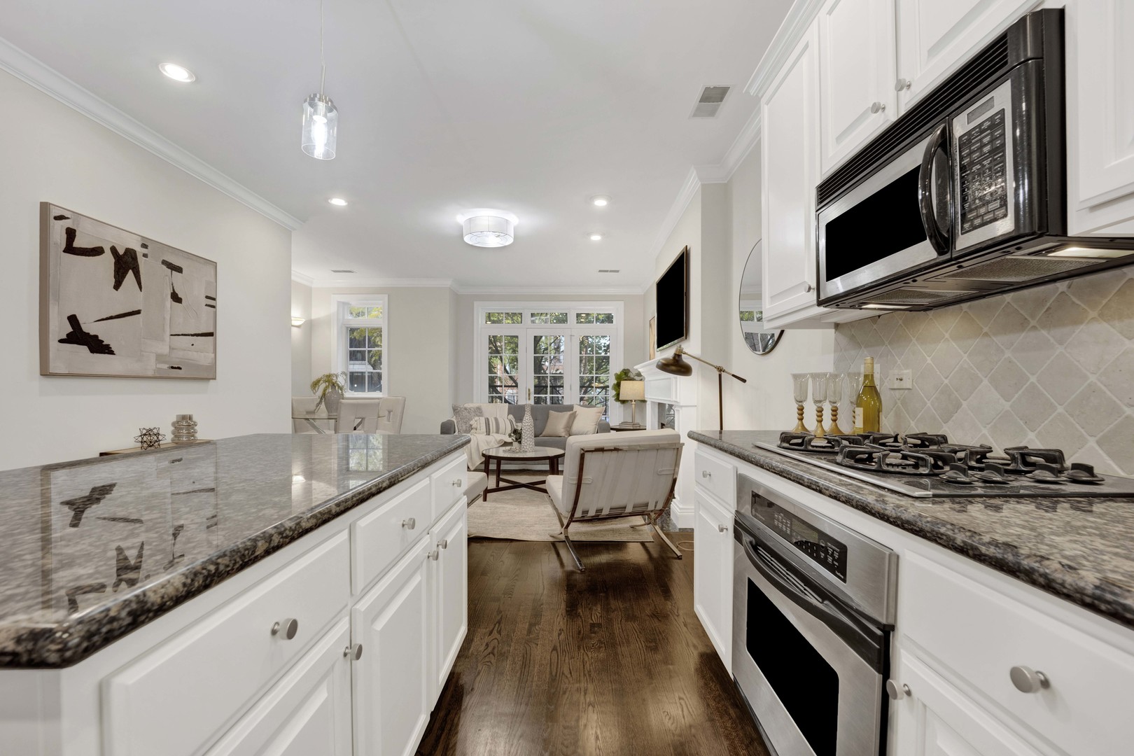 1724 North Mohawk Street, Unit 2 Chicago, IL 60614 - Photo 4 of 24 a kitchen with stainless steel appliances granite countertop a stove a sink and a microwave