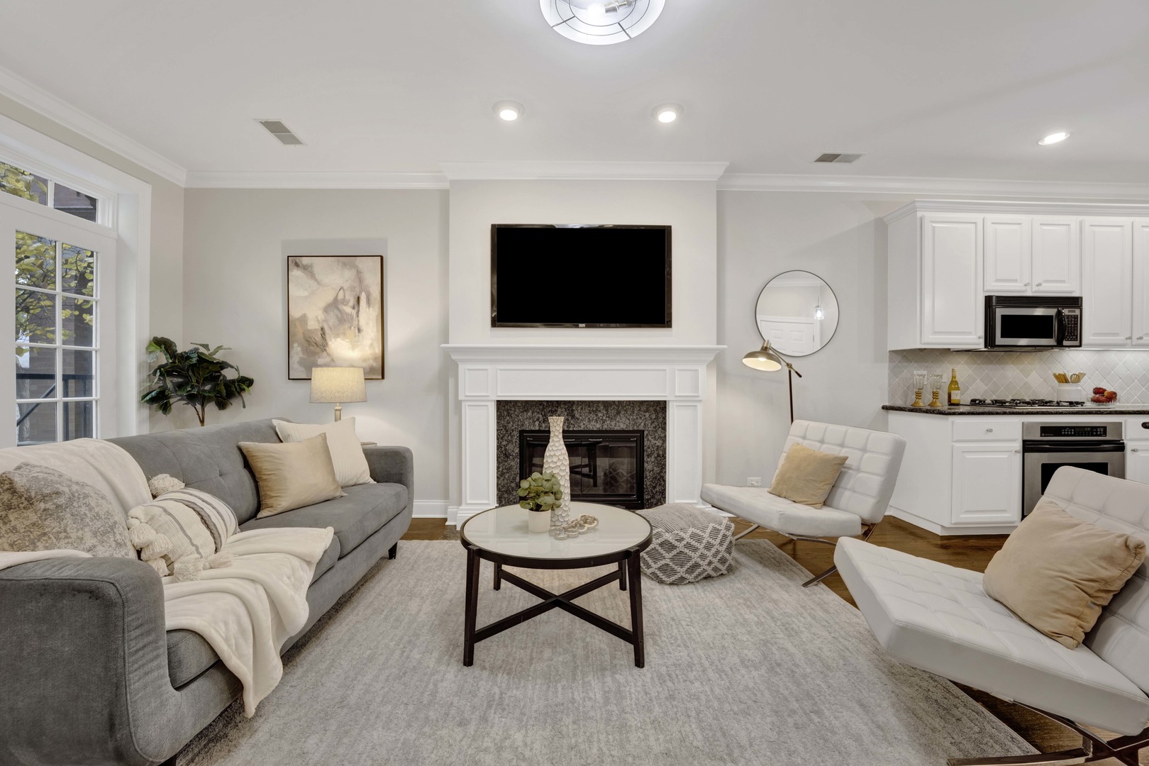 1724 North Mohawk Street, Unit 2 Chicago, IL 60614 - Photo 8 of 24 a living room with furniture a fireplace and a flat screen tv
