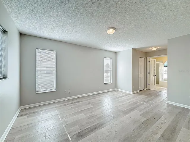 an empty room with windows and closet