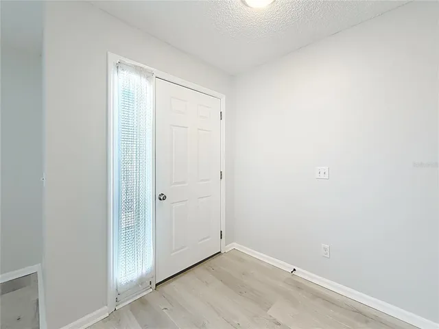 an empty room with wooden door