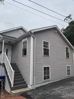 a front view of a house with stairs