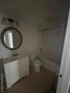 a bathroom with a toilet sink vanity and mirror
