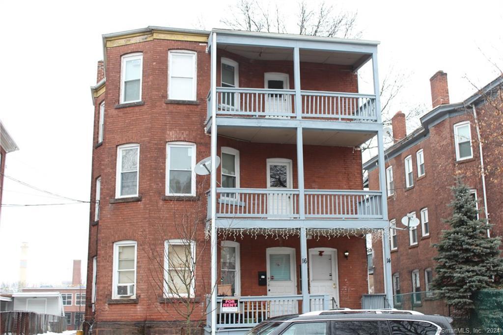 a front view of a building with a yard