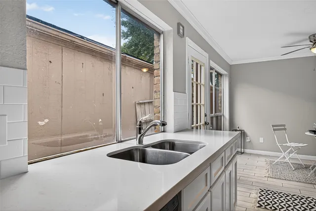 a kitchen with a sink and a refrigerator