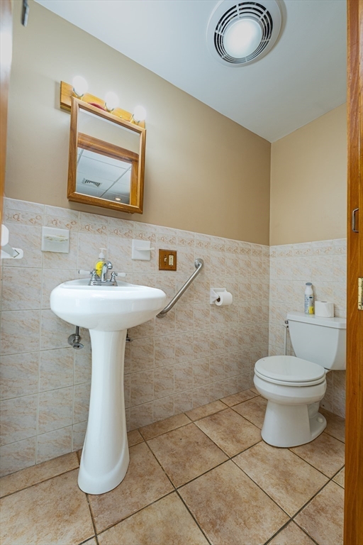 96 Clark Street Everett, MA 02149 - Photo 11 of 26 a bathroom with a sink toilet and a mirror