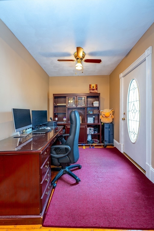96 Clark Street Everett, MA 02149 - Photo 14 of 26 a view of a workspace with furniture and a gym