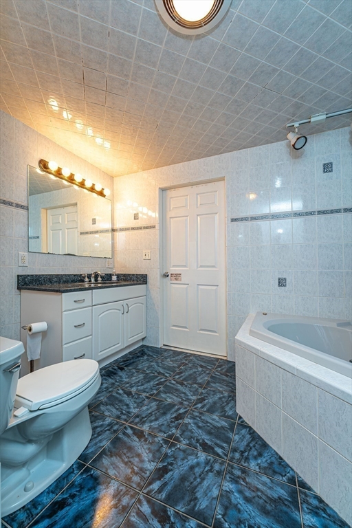 96 Clark Street Everett, MA 02149 - Photo 16 of 26 a bathroom with a sink a toilet and bathtub