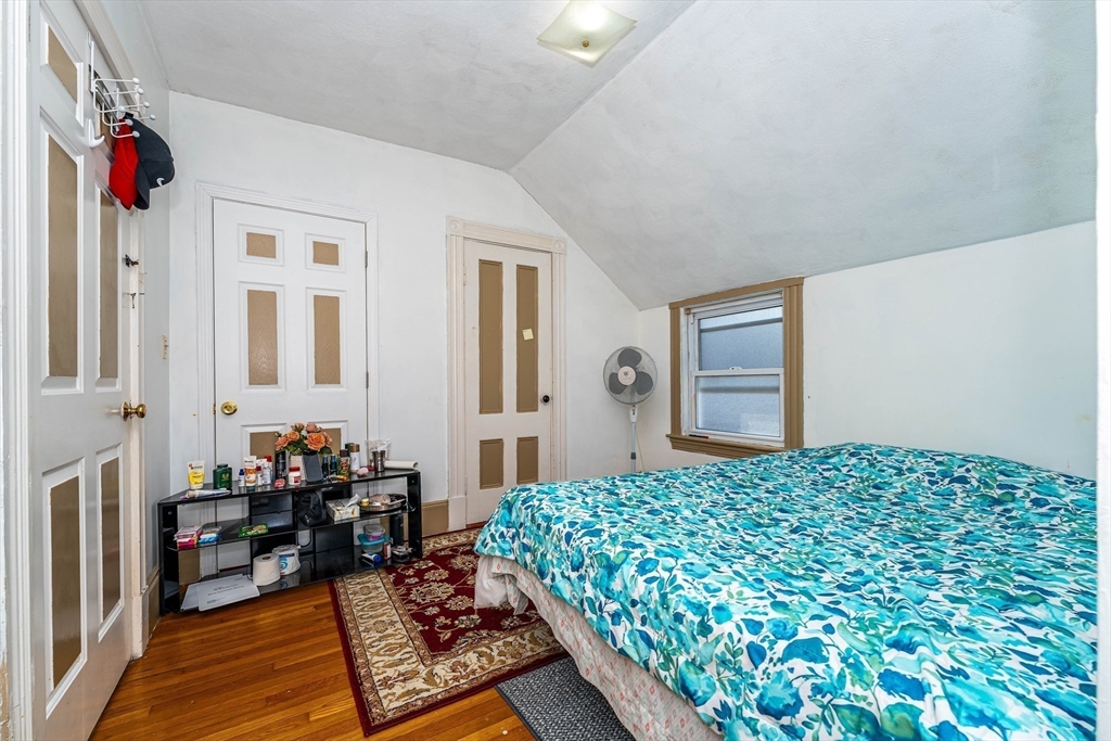 96 Clark Street Everett, MA 02149 - Photo 17 of 26 a bedroom with furniture and a window