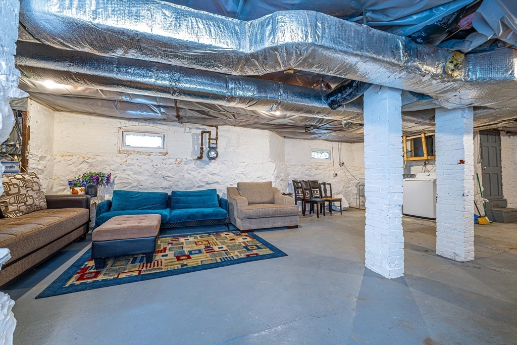 96 Clark Street Everett, MA 02149 - Photo 24 of 26 a outdoor space with lots of furniture and chandelier