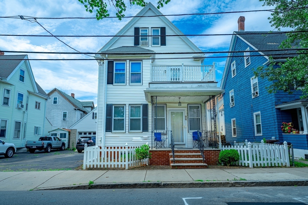 96 Clark Street Everett, MA 02149 - Photo 3 of 26 a front view of a house with a garden