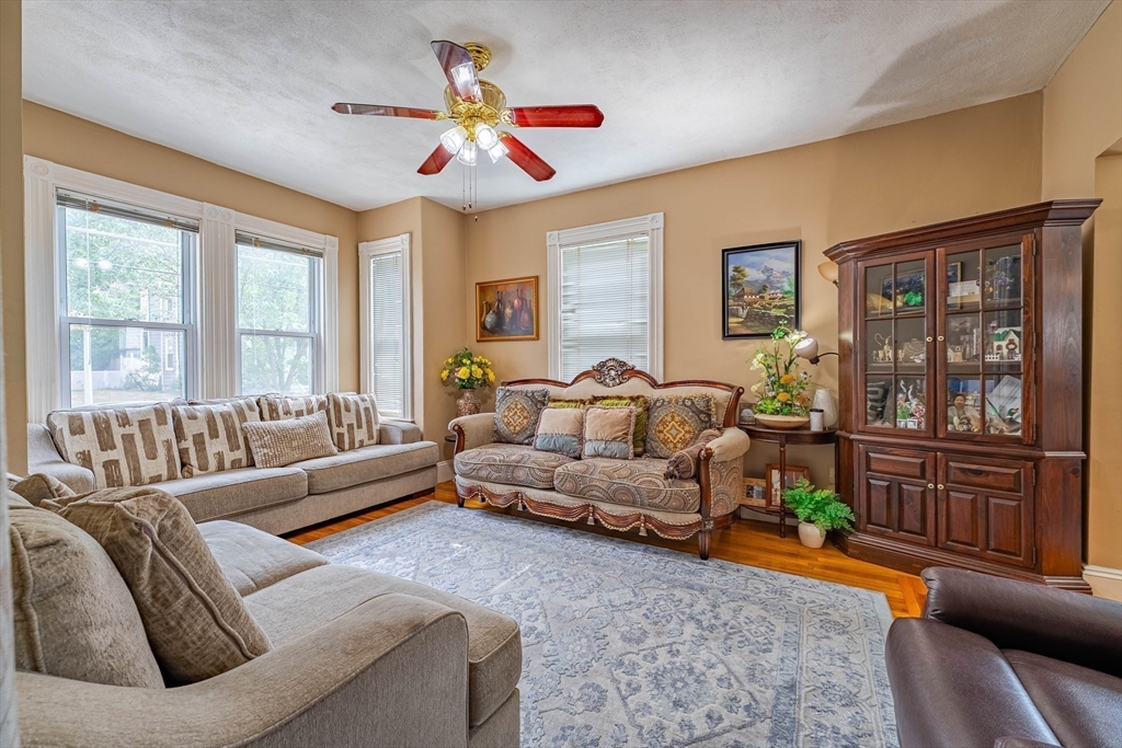 96 Clark Street Everett, MA 02149 - Photo 5 of 26 a living room with furniture and a large window