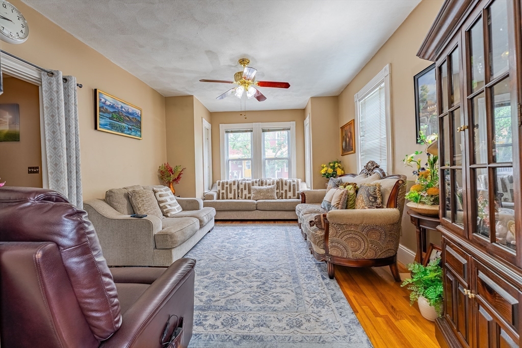 96 Clark Street Everett, MA 02149 - Photo 6 of 26 a living room with furniture fireplace and a large window