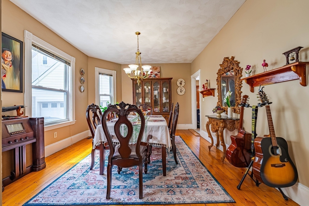 96 Clark Street Everett, MA 02149 - Photo 7 of 26 a view of a dining room with furniture and wooden floor