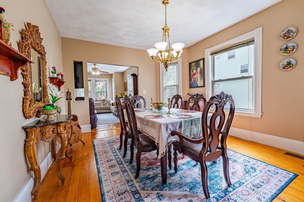96 Clark Street Everett, MA 02149 - Photo 8 of 26 a view of a dining room with furniture and a chandelier