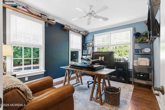 a kitchen with stainless steel appliances granite countertop a sink dishwasher and white cabinets with wooden floor