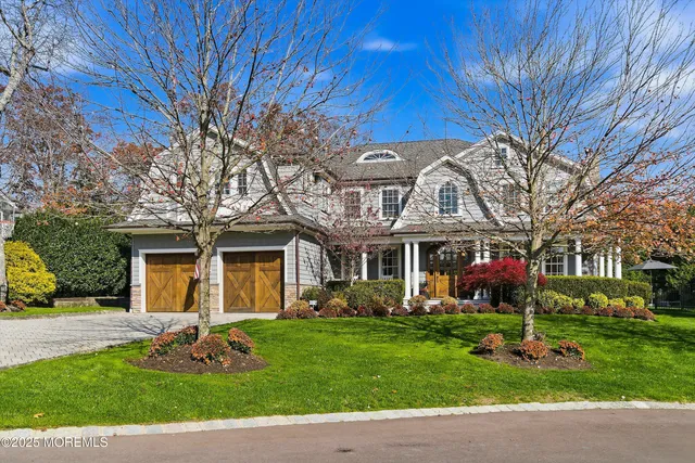 a front view of a house with a garden and plants