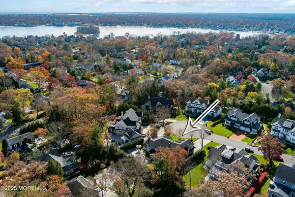 a front view of a house with a garden and trees