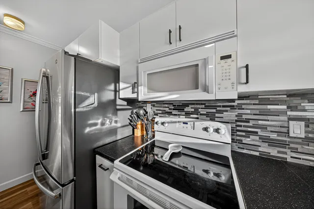 a living room with furniture a clock and a large window