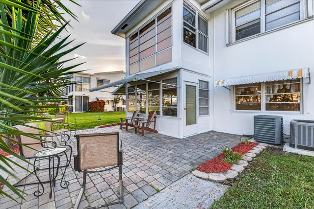 a view of a house with backyard porch and sitting area