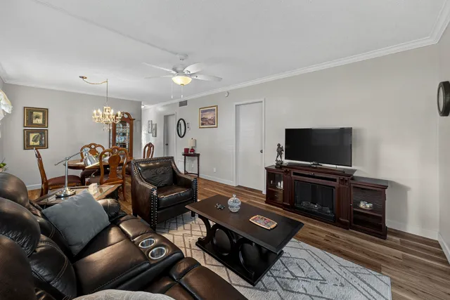 a bathroom with a sink a toilet a mirror and shower